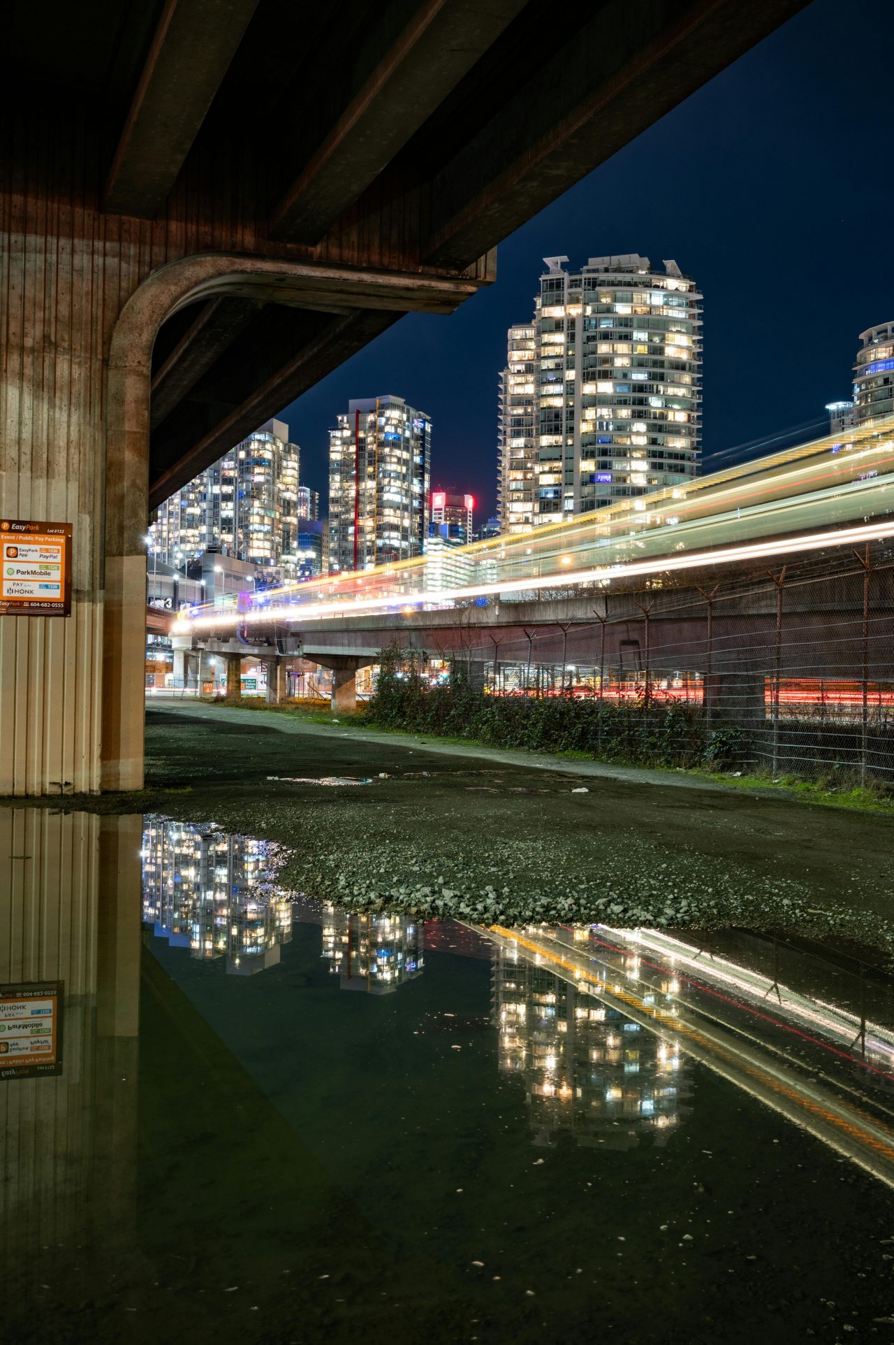 Gray concrete bridge near city buildings